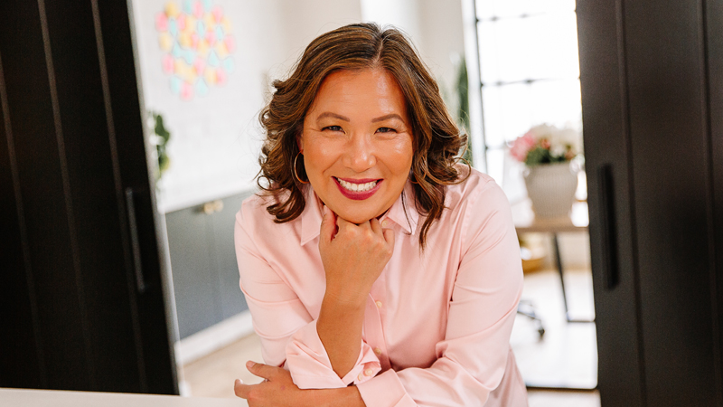 Headshot of Joanne Chu wearing pink shirt