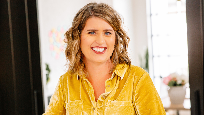 Headshot of Shannon Rush-Call wearing bright yellow shirt