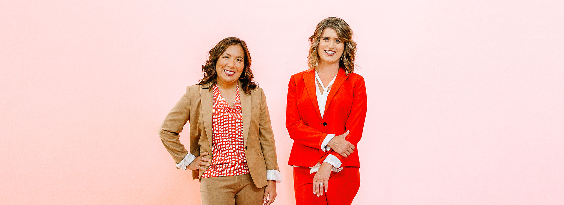 Shannon and Joanne standing in front of pink background