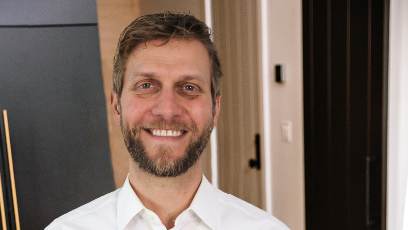 Headshot of John Silkey wearing a white dress shirt